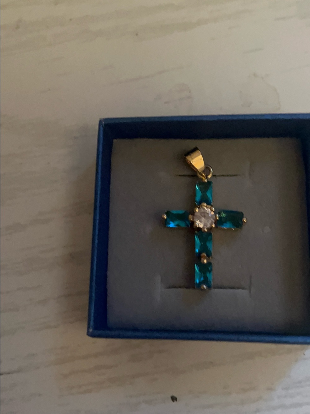 Gold-Tone Cross Pendant with Teal Stones and Clear Center